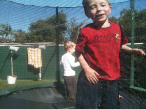 Marcus and his best friend Cohan jumping with soft green Blue Couch under the trampoline.